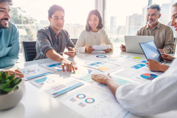 A team of professionals collaborating on data reports, symbolising how Just Ask Klea simplifies access to legal entity information through AI-driven insights.