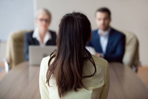 A professional facing a board during a meeting, symbolising how AGMs in Denmark hold directors accountable while ensuring transparent communication between management and shareholders.