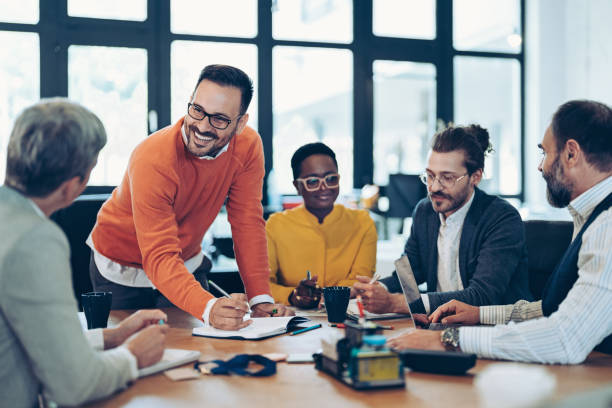 A diverse group of professionals collaborating around a table, representing how AGMs in Uruguay foster open dialogue, strategic decision-making, and transparent governance among company leaders.