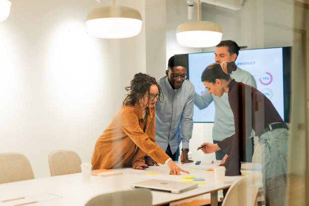 A group of professionals collaborating in a meeting room, representing how AGMs in the UAE bring partners together to plan strategy, review performance, and ensure compliance with corporate governance standards.