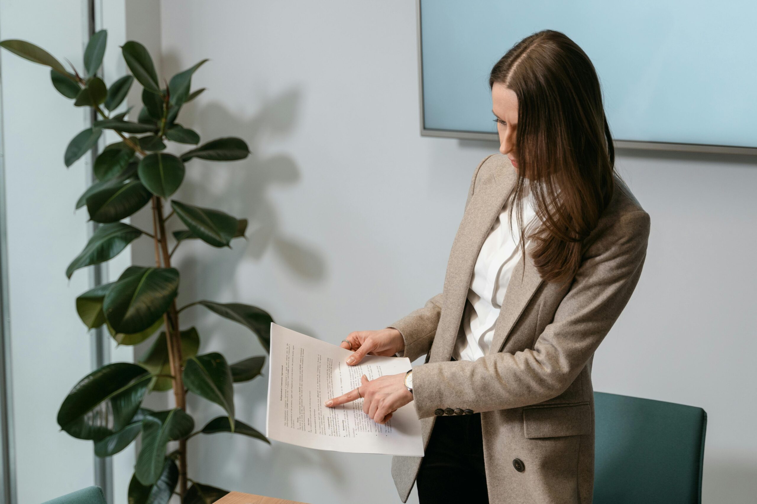 Businesswoman reviewing director appointment documents during a board meeting in Bulgaria.