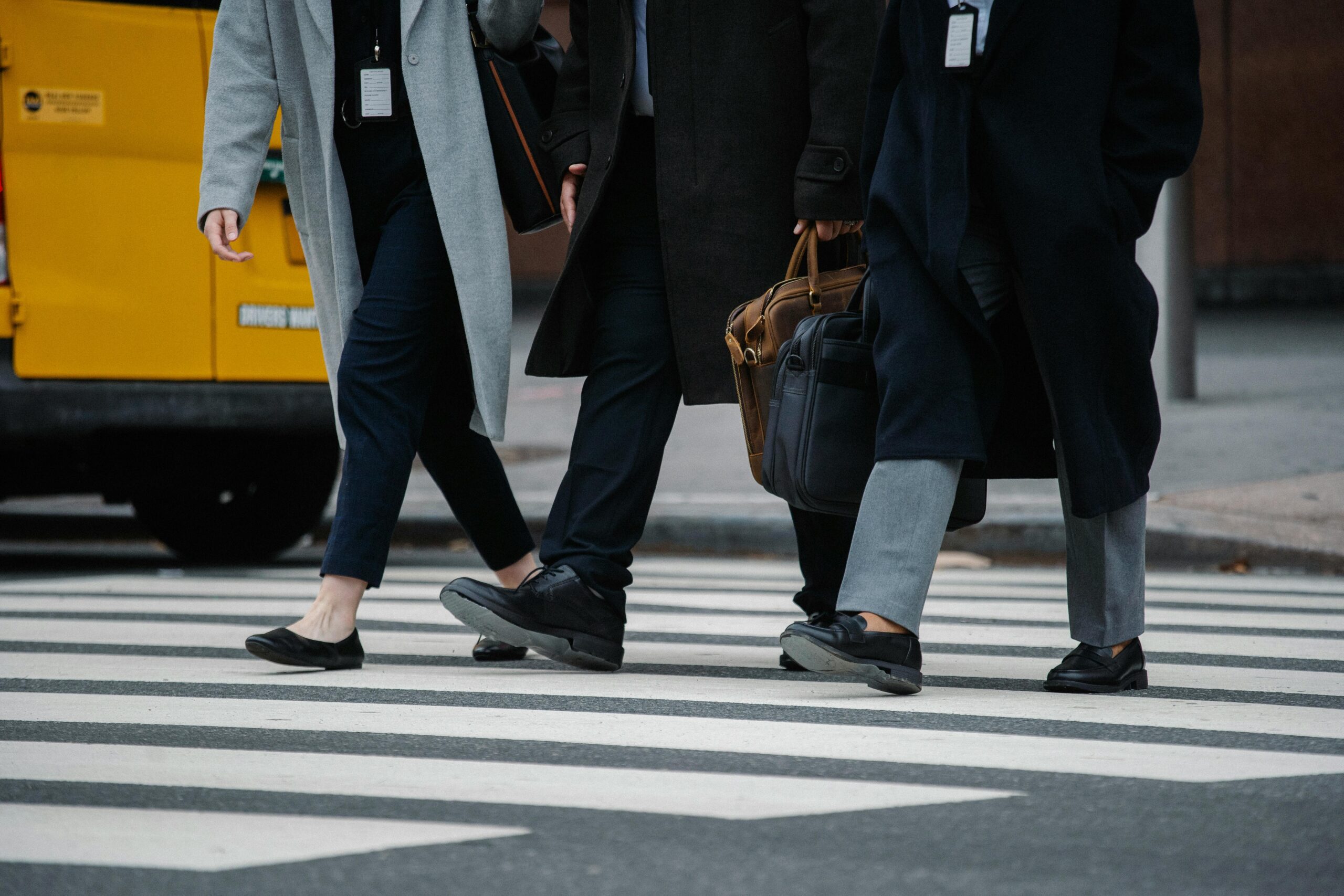 Three business professionals crossing a street, symbolising corporate compliance and timely action, relevant to Annual General Meeting obligations in Croatia.