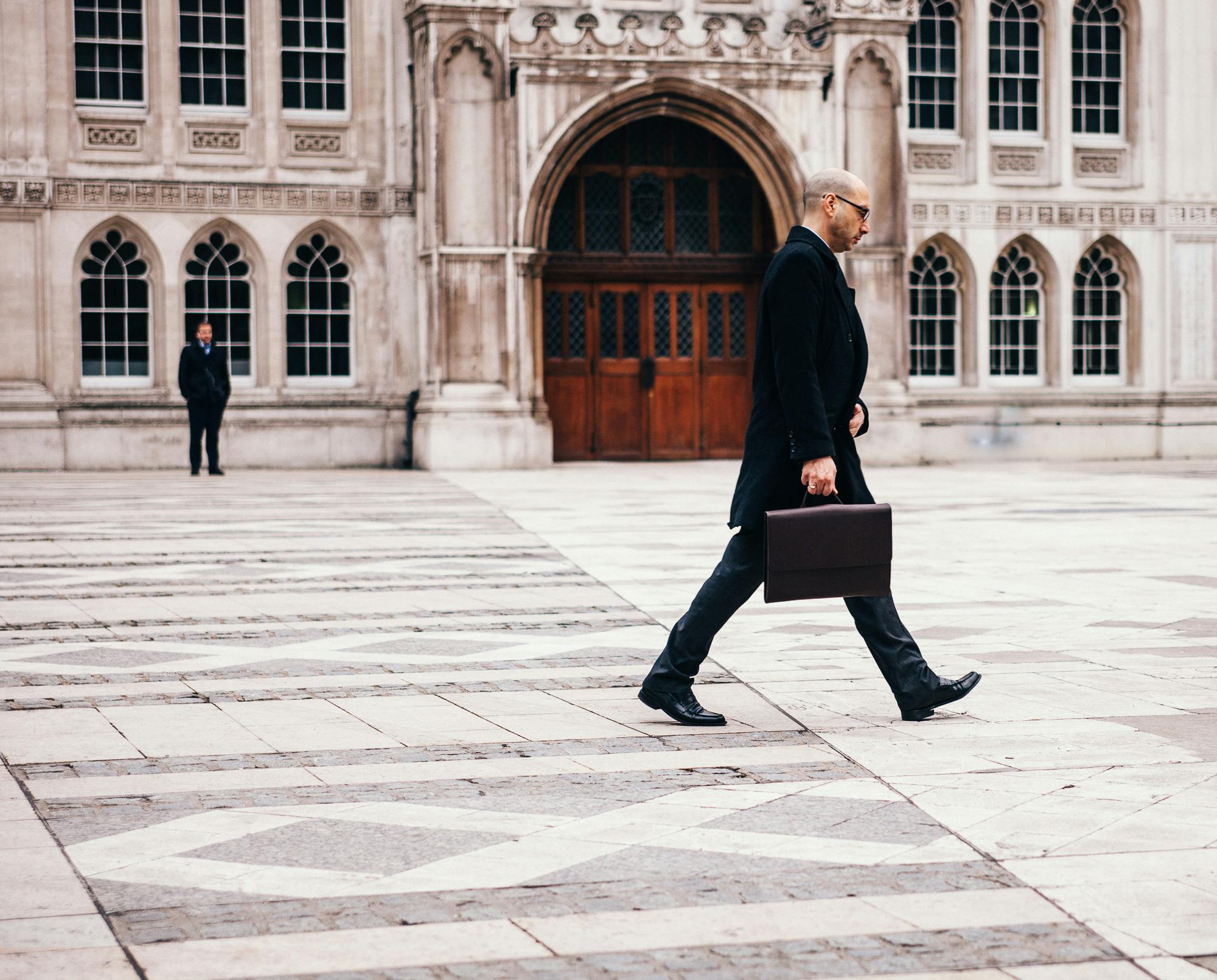 A businessman walking confidently, symbolising leadership and compliance during an Annual General Meeting in Georgia.